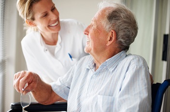 Older Man in Wheelchair with Young Woman